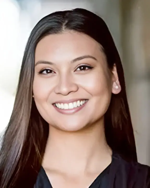 Smiling woman with long brown hair.