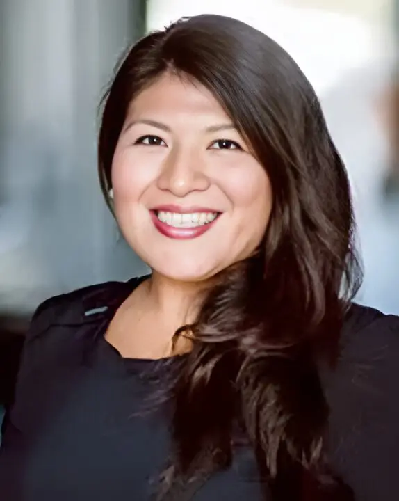 Smiling woman with long brown hair.