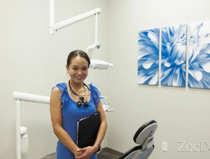 Smiling female dentist in dental office.